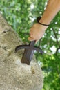 hand and sword in the stone as in the legend of King Arthur Royalty Free Stock Photo
