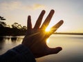 Hand symbol against sunlight