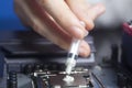 Hand with syringe applying thermal paste on the CPU processor on motherboard Royalty Free Stock Photo