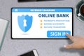 Hand with tablet pc tapping button sign in on stone table background - internet online banking technology concept