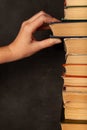 Hand takes a book. Vintage paper library books for reading, education and literature. Knowledge is power