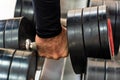 Hand takes chrome dumbbell close