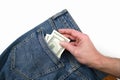 Hand takes dollar bills in the back pocket of jeans Royalty Free Stock Photo