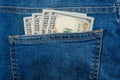 Hand takes out 100 dollars from the pocket of blue jeans. Close-up. Royalty Free Stock Photo