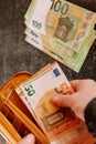 hand takes out euro bill from the wallet. Earnings and spending in the Eurozone. Royalty Free Stock Photo