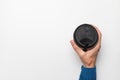 hand takes a paper cup of coffee with a plastic black lid on a white background, top view. Takeaway coffee banner Royalty Free Stock Photo