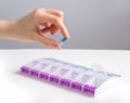 Hand taking capsule from pill case, bbo, organizer