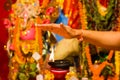A hand taking heat of the flame as blessing from a lit clay lamp on top of a clay stand or worship idol durgapuja india diwali