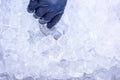 Hand taking ice with metal scoop for preparing cocktail Royalty Free Stock Photo