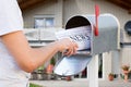 Hand Taking Newspaper From Mailbox Royalty Free Stock Photo