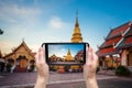 Hand taking photo at Wat phra that hariphunchai Royalty Free Stock Photo