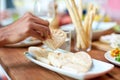 Hand taking piece of bread from plate Royalty Free Stock Photo