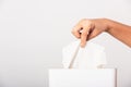 Hand taking pulling white facial tissue out of from a white box Royalty Free Stock Photo