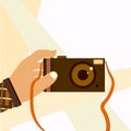 Hand taking selfie shot with retro photo camera