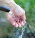 Hand in tap water in nature Royalty Free Stock Photo