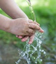 Hand in tap water in nature Royalty Free Stock Photo
