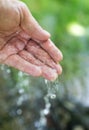 Hand in tap water in nature Royalty Free Stock Photo