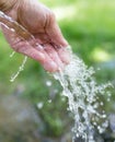 Hand in tap water in nature Royalty Free Stock Photo