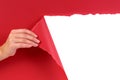 Hand tearing red paper background revealing white copy space Royalty Free Stock Photo