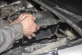 A hand technician checking or fixing the engine of a modern car. Replacement of the air filter Royalty Free Stock Photo