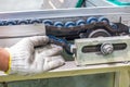 The hand of technician checking strength and tension of conveyor belt for maintenance Royalty Free Stock Photo