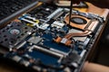 Hand technician repairing broken laptop notebook computer with a screwdriver Royalty Free Stock Photo