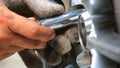 Hand of technician tiding nut bolt on car wheel