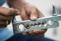 The hand of technician with tube flaring tool in air condition service. Royalty Free Stock Photo