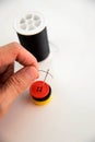 Hand threading a needle with black thread