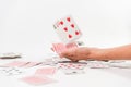 hand throwing cards, cards on the table