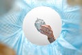 hand throwing crumpled foil into trash can Royalty Free Stock Photo