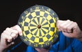 Hand throwing dart to dartboard Royalty Free Stock Photo