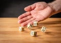 Hand throwing dice in front of a dark background Royalty Free Stock Photo