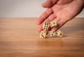 Hand throwing dice in front of a dark background Royalty Free Stock Photo