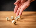 Hand throwing dice in front of a dark background Royalty Free Stock Photo