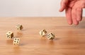 Hand throwing dice in front of a dark background Royalty Free Stock Photo