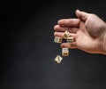 Hand throwing dice in front of a dark background Royalty Free Stock Photo