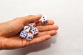 Hand throwing dice on white background