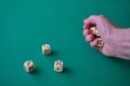 Hand throwing dices on the green table Royalty Free Stock Photo