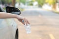 Hand throwing plastic bottle on the road Royalty Free Stock Photo