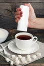 Hand throwing sweetener tablets Royalty Free Stock Photo