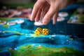 The hand throws two yellow dice on the playing field. Gaming moments in dynamics. Concept Board games strategy Royalty Free Stock Photo