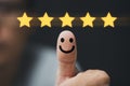 Hand and thumb rise up with five yellow stars on black background, Best customer satisfaction and evaluation for good quality Royalty Free Stock Photo