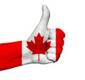 Hand with thumb up painted in colors of Canada flag isolated