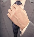 hand tie necktie of man in suit closeup, formal fashion