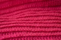 The hand-tied magenta-colored knitted canvas is like a background.