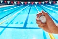 Hand, timer and swimming pool for sport, training and workout with preparation for competition. Person, coach or mentor Royalty Free Stock Photo