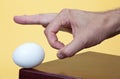 Hand about to flick an egg