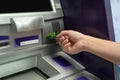 Hand about to insert card to ATM machine ready to withdraw or transfer money Royalty Free Stock Photo