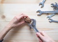 Hand, tool and big walnut on wooden background. The concept of complex problems, the challenge can be solved. Royalty Free Stock Photo